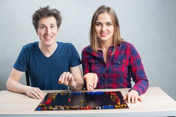 Board game play, young family couple have fun staying home