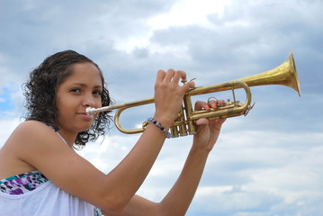 Female trumpet player expressions outdoors.