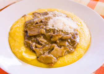 hot and steaming corn polenta topped with mushroom sauce ready for your meal