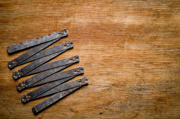 Measuring iron folding meter old, photographed on a shabby wooden surface.