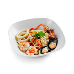 Fried udon noodles in a seafood wok. Traditional asian food. Isolated on a white background.