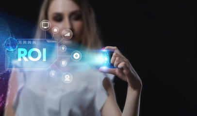 Business, Technology, Internet and network concept. Young businessman working on a virtual screen of the future and sees the inscription: ROI