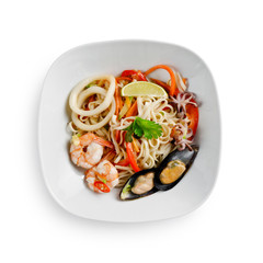 Fried udon noodles in a seafood wok. Traditional asian food. Isolated on a white background.