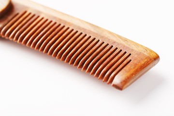 Wooden comb made of natural sandalwood for men on a white background.