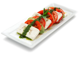 feta salad with zukkini tomato and pesto on isolated white background