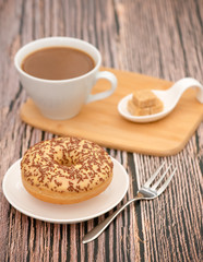 Dessert, Donuts, chocolate and strawberry circles, sugar and cream on Donuts and hot coffee cups, preparation for a break or party on the wooden table background.