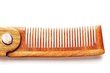 Wooden comb made of natural sandalwood for men on a white background.