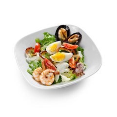 Seafood salad. Mussels, scallops, shrimp and squid with cherry, egg and sauce. Isolated on a white background.