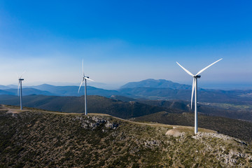 Windmill farm in Greece. Wind energy on mountains view