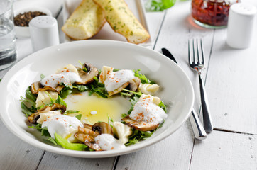 Appetizer with mozzarella cheese, arugula and mushrooms