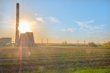 Open-type cooling towers of CHP combined heat and power station at sunset