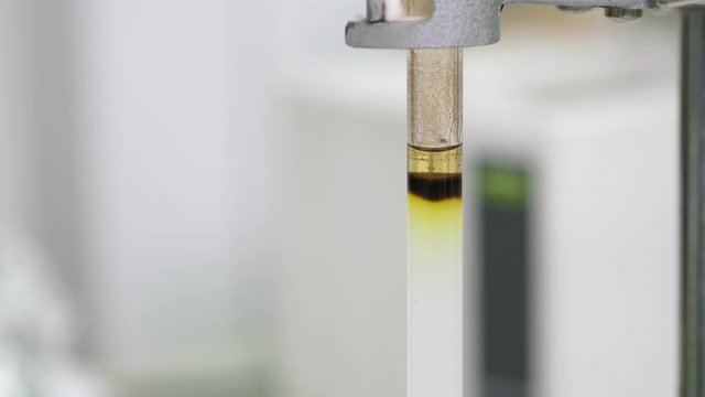 Black sample was added into a glass column and used solvent to elute the sample out of the column. Silica gel was packed into a column. Column chromatography technique. Education and analysis concept.