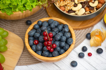 Group Fruits Breakfast mixed vegetables with salad bowl, nuts bowl, strawberry, banana, and pineapple, orange juice,  vitamin c in food  nature for health and diet in the top view on the wood table.