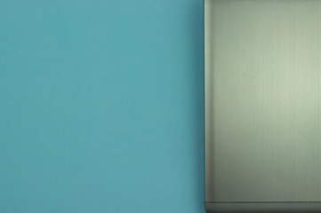 Silver laptop isolated on a blue background. Information Technology Concept.