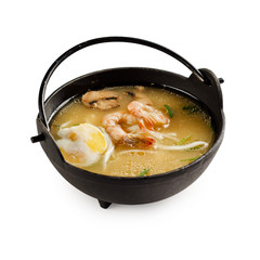 Traditional japanese miso soup with shrimp, mushrooms and egg on a white background