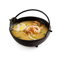 Traditional japanese miso soup with shrimp, mushrooms and egg on a white background