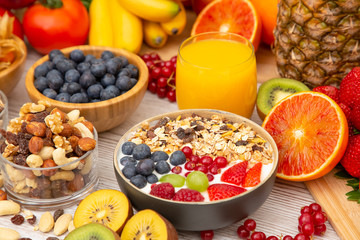 Group Fruits Breakfast mixed vegetables with salad bowl, nuts bowl, strawberry, banana, and pineapple, orange juice,  vitamin c in food  nature for health and diet in the top view on the wood table.