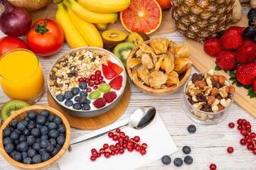 Group Fruits Breakfast mixed vegetables with salad bowl, nuts bowl, strawberry, banana, and pineapple, orange juice,  vitamin c in food  nature for health and diet in the top view on the wood table.