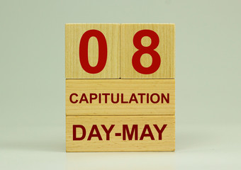May 8 on the calendar. Victory Day. Calendar on a white background. Word capitulation on wooden cubes. The concept of one day a year.