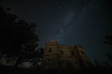 Milky way with medieval castle in the background