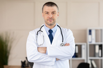 Portrait of mature doctor looking at camera