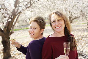 Outdoor portrait of two best friends women celebrating the end of isolation