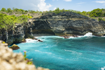(Selective focus) Stunning view of a rocky cliff bathed by a turquoise sea, Broken Beach, Nusa Penida. Nusa Penida is an island southeast of Bali, Indonesia.