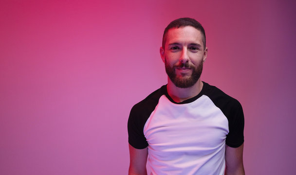 smiling man on neon colorful saturated gradient background
