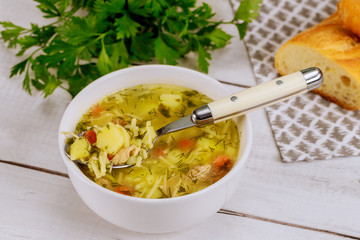 Hot homemade chicken noodle soup in spoon.