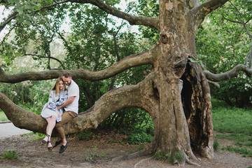 Romantic and happy caucasian couple in casual clothes hugging on the background of beautiful nature. Love, relationships, romance, happiness concept. Man and woman walking outdoors together.