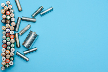 Many used batteries from different manufacturers. Old batteries for recycling.