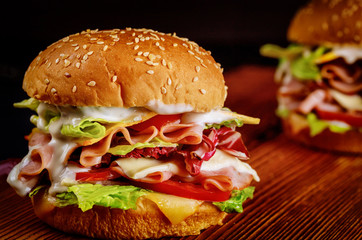 Deli meat and cheese sandwiches with vegetable.