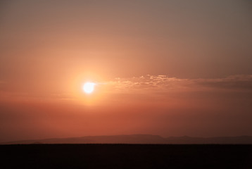Orange warm sunrise in the mountains. Sunset in the mountains.