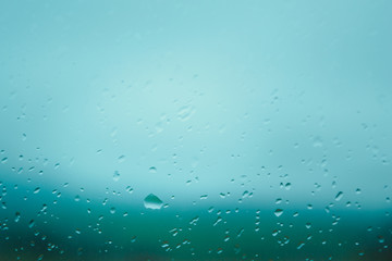Window after rain, glass with drops in the car.