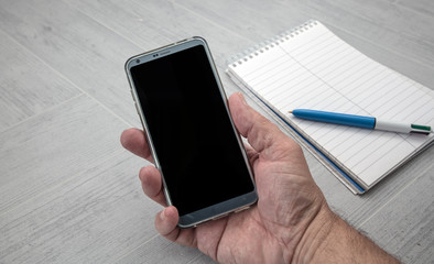 male hand holding mobile phone