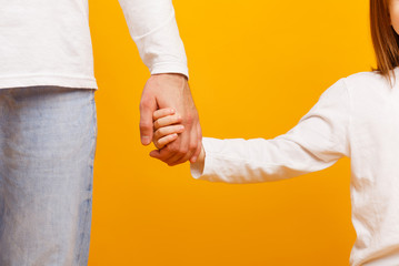 Cropped of father and daughter holding hands