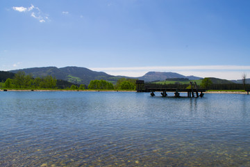 Beautiful lake in the Alps mountains, Austria. Summer relaxation area near the lake.