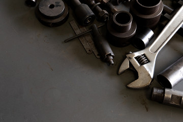 old tools on mechanic's desk background