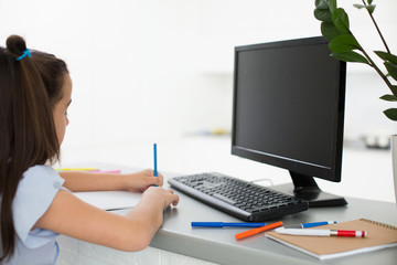 Fototapeta na wymiar Pretty stylish schoolgirl studying homework math during her online lesson at home, social distance during quarantine, self-isolation, online education concept, home schooler