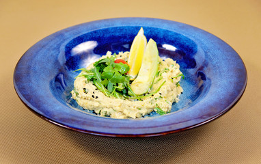 Hummus with avocado, cherry and arugula in Mediterranean