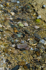 Naklejka na ściany i meble Stones underwater in the sea or lake. Background with water and stones.