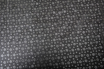 Starry tablecloth on the black table. Abstract Christmas background