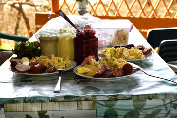 People eating traditional easter food with salad, ham eggs, beetroot and horseradish