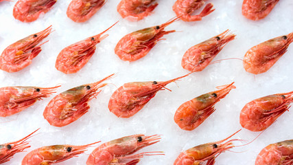 Boiled and frozen shrimp on ice in a fish store.