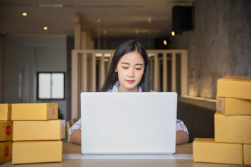 Portrait of Young asian working online shopping with laptop computer at home. Selling online and delivery concept