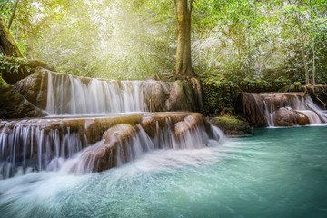 Waterfall in the jungle forest in Thailand. beautiful forest landscape, trees water and sun
