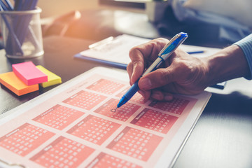 Planner write meeting agenda at Calendar, work online at home. Man plan daily appointment and note holiday trip schedule in diary at office desk.Calendar reminder event concept.