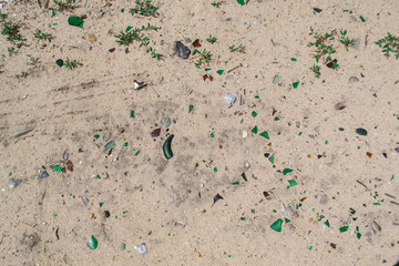 Sand background with broken glass
