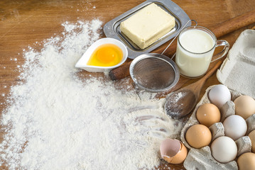 on the table are cooking items such as eggs, flour, kitchen utensils. favorite job.