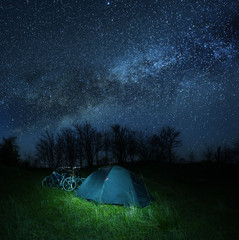 touristic cycling camp at the night under a starry sky, outdoor travel scene